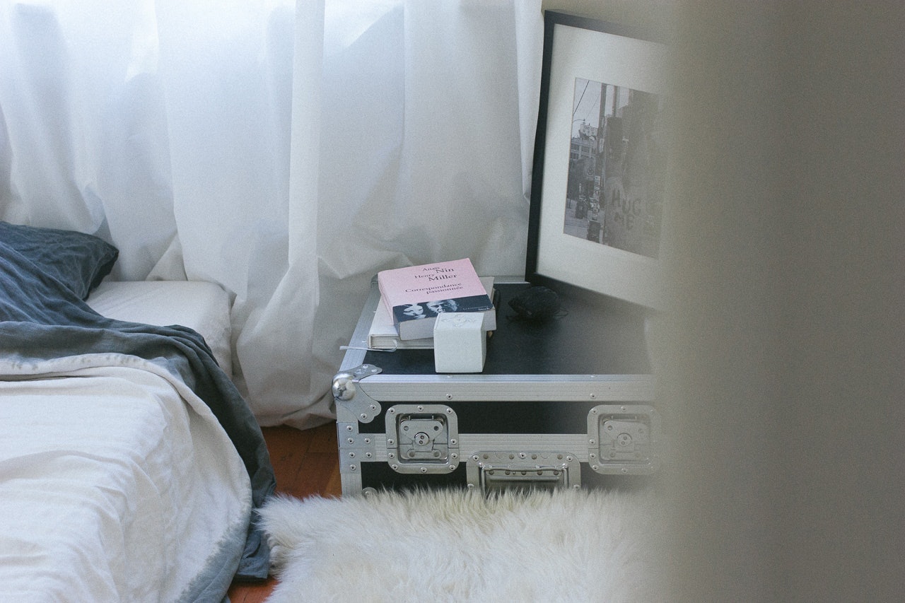 Books on bedside table by Conscious by Chloé