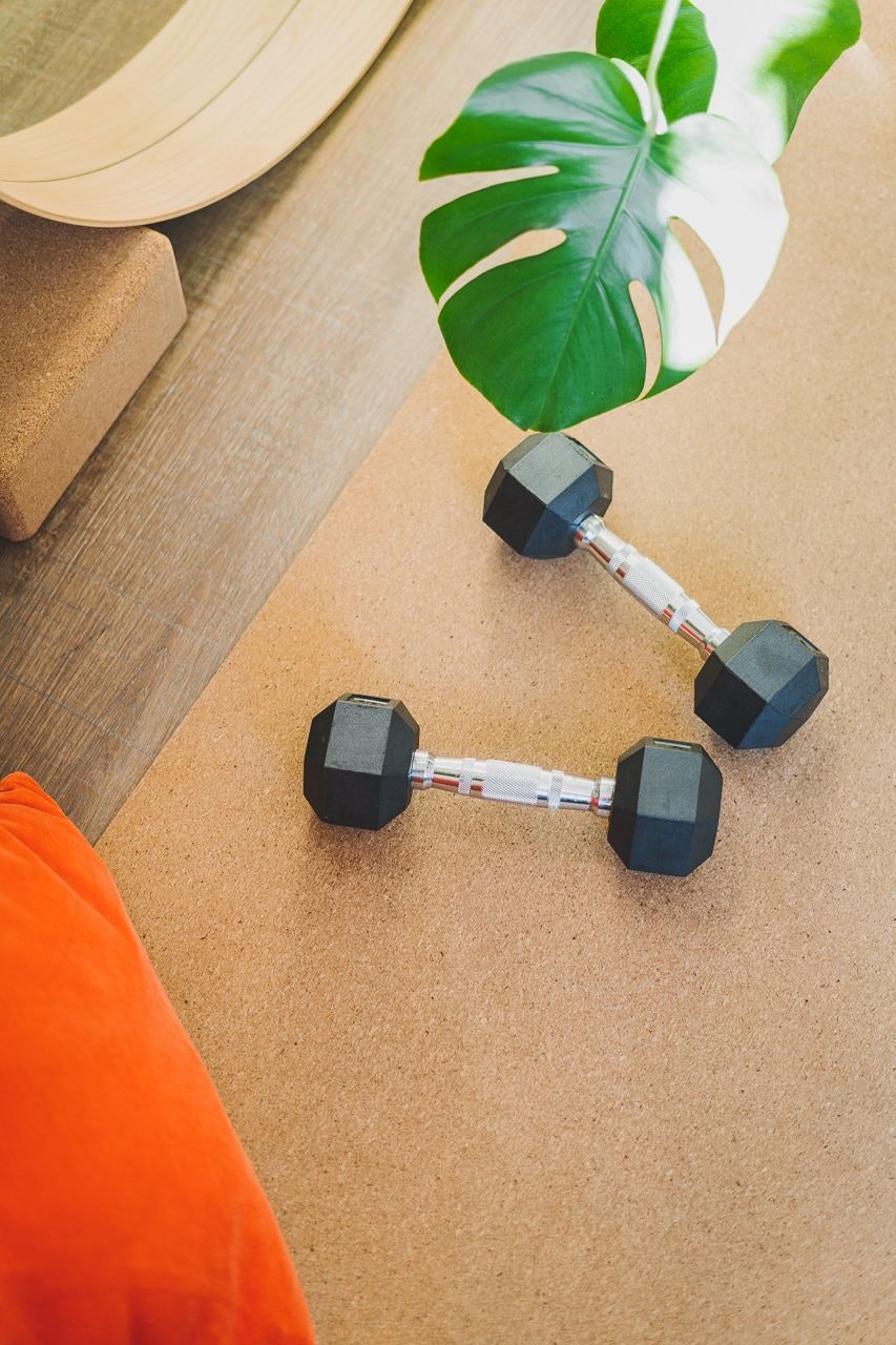 The Four Exhilarations Exercise weights on a yoga mat minimalist aesthetic by Conscious by Chloé